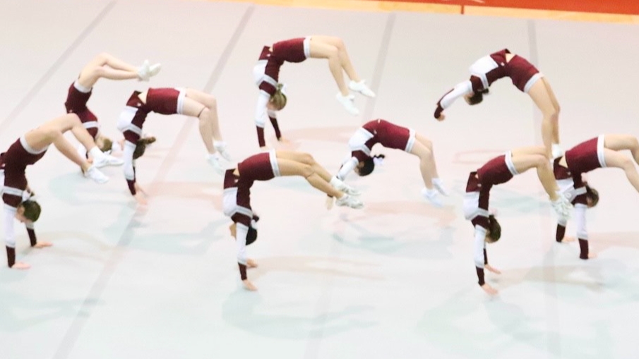 cheerleaders perform flips