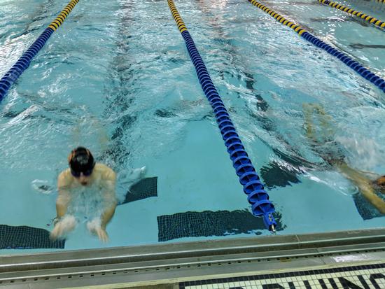 Tyler Newsom reaches for wall in 100 Breast 