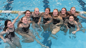 9 high school girls together in a swimming pool