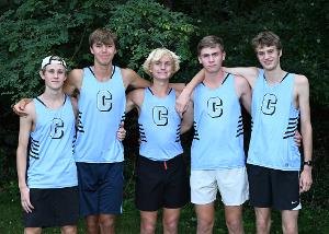 5 high school boys cross country athletes standing together